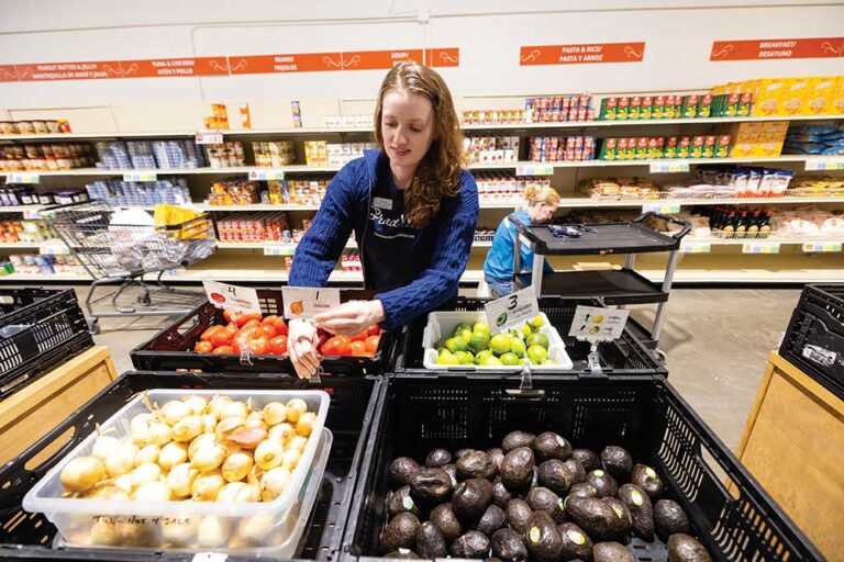 Volunteers stock fresh produce in the food pantry at GraceWorks Ministries in Franklin, Tennessee.