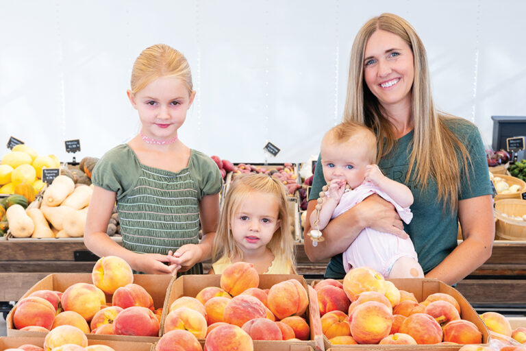 Ashley Brown with her daughters, Addy, 6, Ella, 4, and Raleigh, 7 months, with some fresh peaches at BlueRock Farm Market in Twin Falls, Idaho.