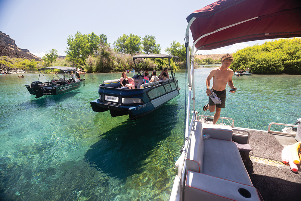 A tour guide from Banbury Adventures anchors a pontoon boat at Blue Heart Springs in Buhl, Idaho.