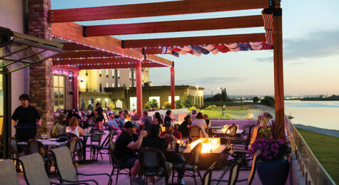 Visitors dine outdoors along the Snake River at dusk at Edgewater Dining & Spirits in Burley, Idaho.