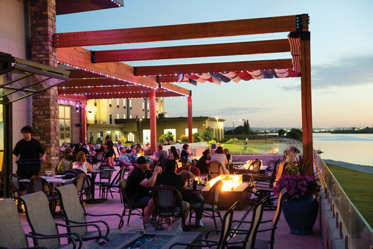 Visitors dine outdoors along the Snake River at dusk at Edgewater Dining & Spirits in Burley, Idaho.