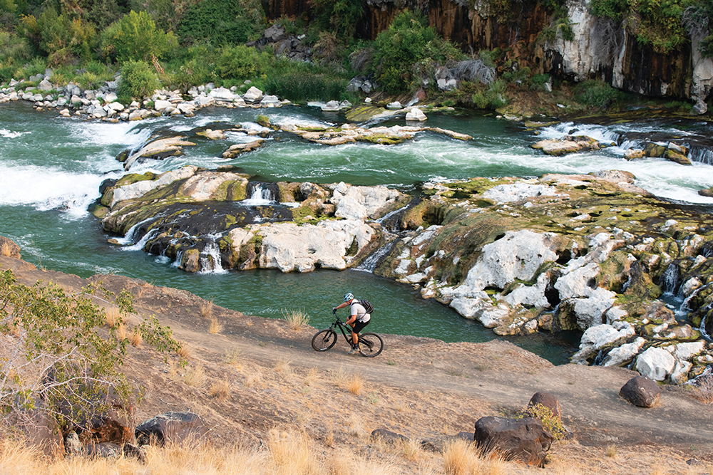 Andrew Perttula, owner of Pertt's Bike Rental, rides a mountain bike at Auger Falls in the Snake River Canyon, in Twin Falls, Idaho.