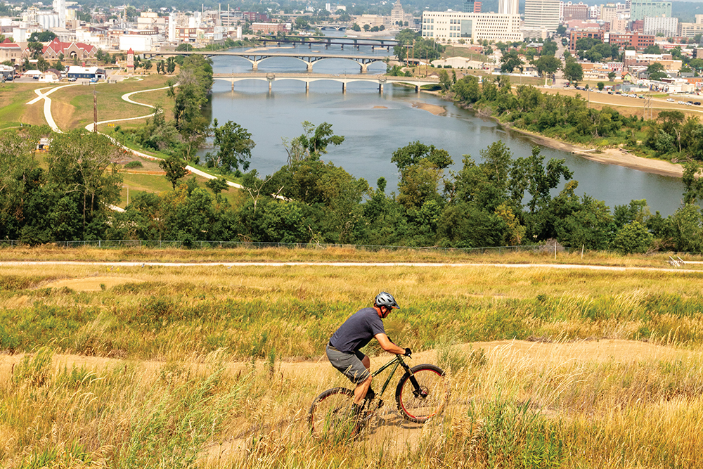 A man rides his bike at Mt Trashmore, one of many trails in Cedar Rapids Iowa for runners and walkers.