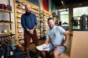 Clifton Trebil-Smith, left, and Jim Dwyer aim to create community connections through the Iowa Running Co. Right: People participate in a weekly Thursday night run that starts and ends at the store.