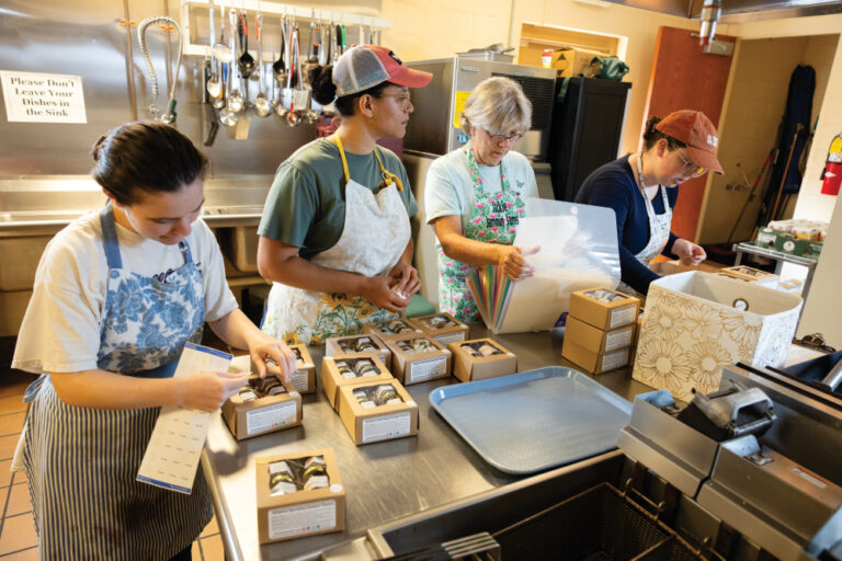 Employees of Jammin Jams label and pack jams into gift boxes in the kitchen at Maryville First Baptist Church in Maryville, Tennessee.