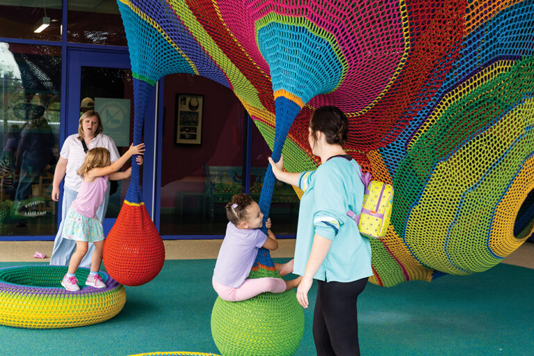 Children climb on colorful structures in the rooftop adventure area at the Kaleideum in Winston-Salem, NC.
