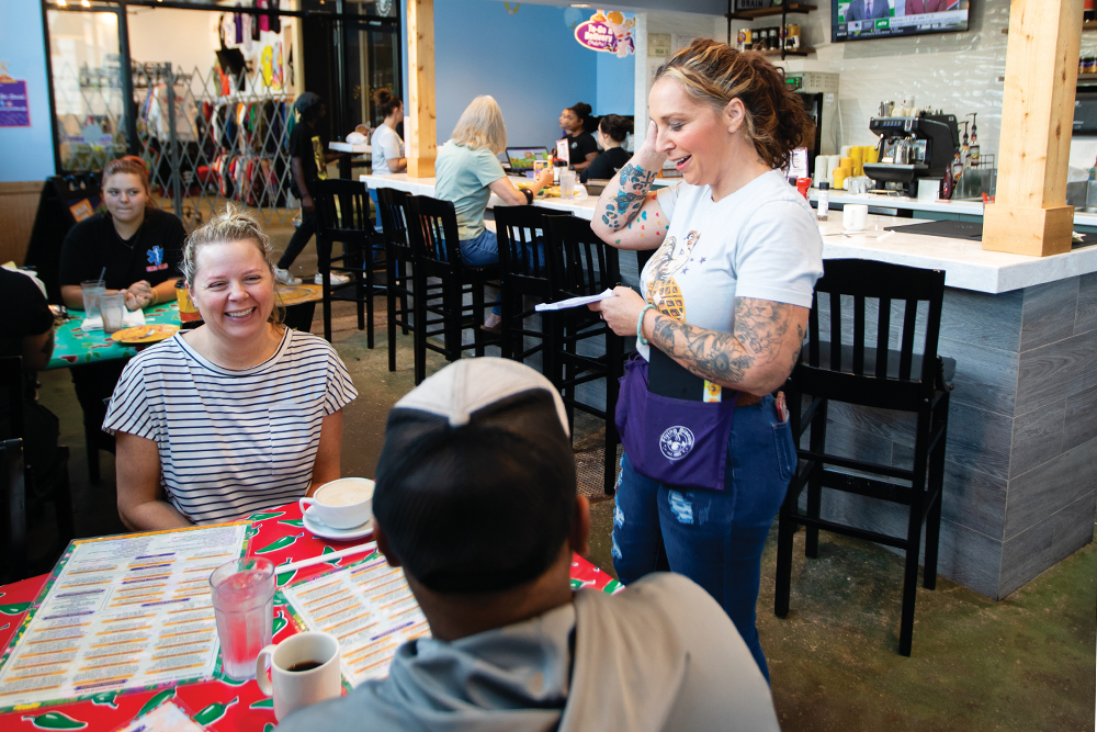 Shelena McHone serves Megan and Shawn McClain at the Flying Biscuit Cafe inside the Highside Market in Columbus.