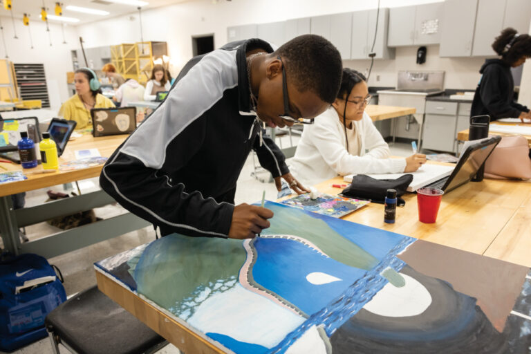 Korderian Patrick works on his painting at the Rainey-McCullers School of the Arts in Columbus.