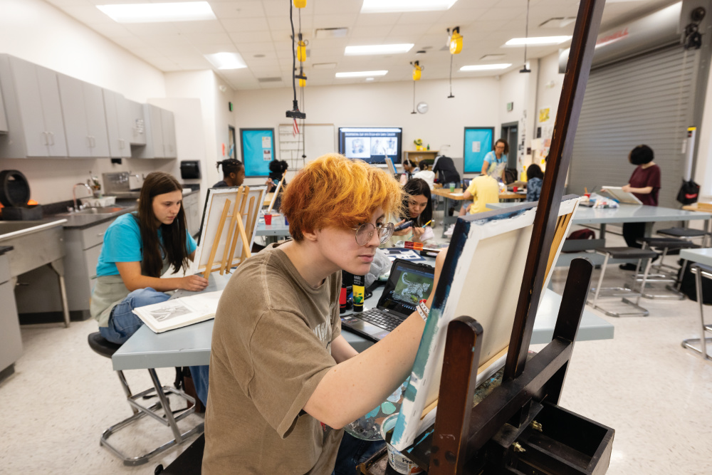 Allison Meredith works on a painting at the Rainey-McCullers School of the Arts in Columbus. 