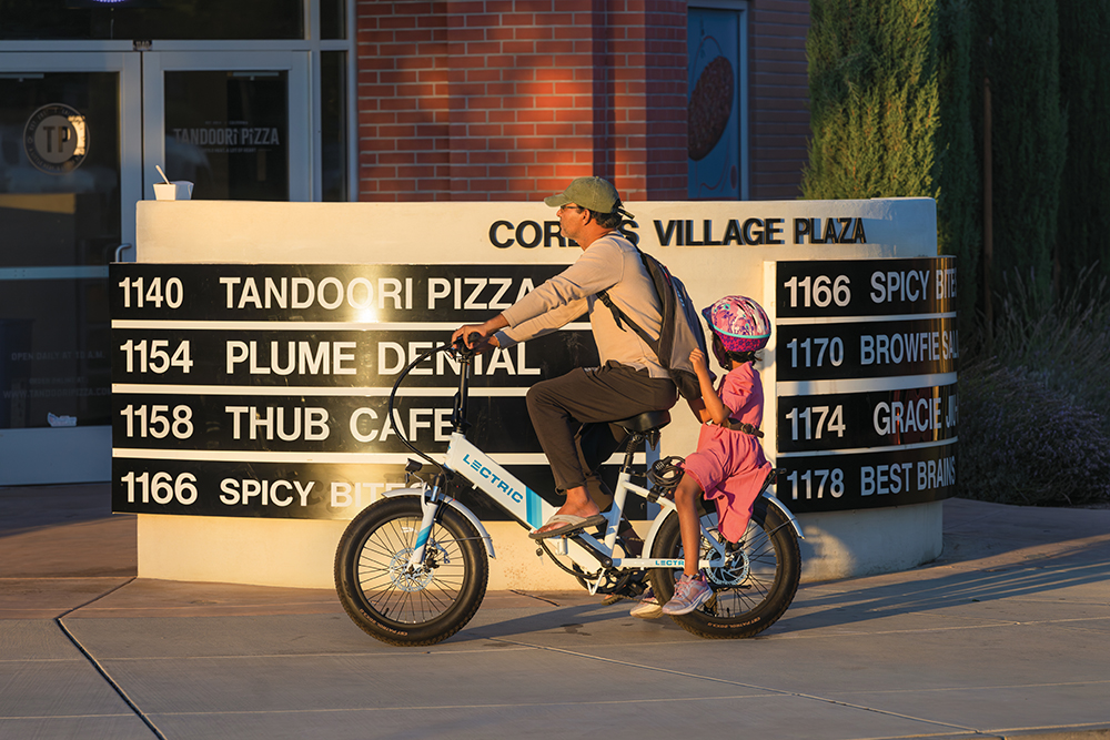 Residents cycle through Cordes Village Plaza in Mountain House, CA.