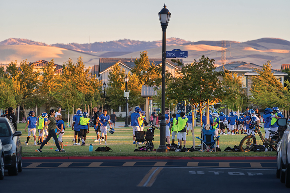 Football teams practice at Cordes Park with a view of the Diablo Range mountains in Mountain House, CA.