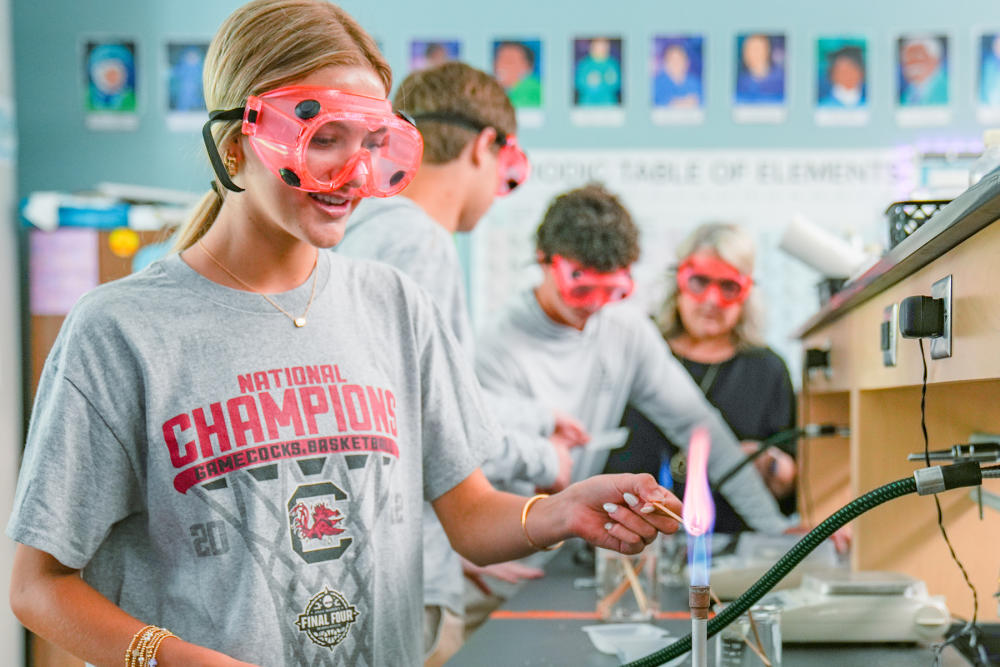 CCES students conduct experiments in a lab.