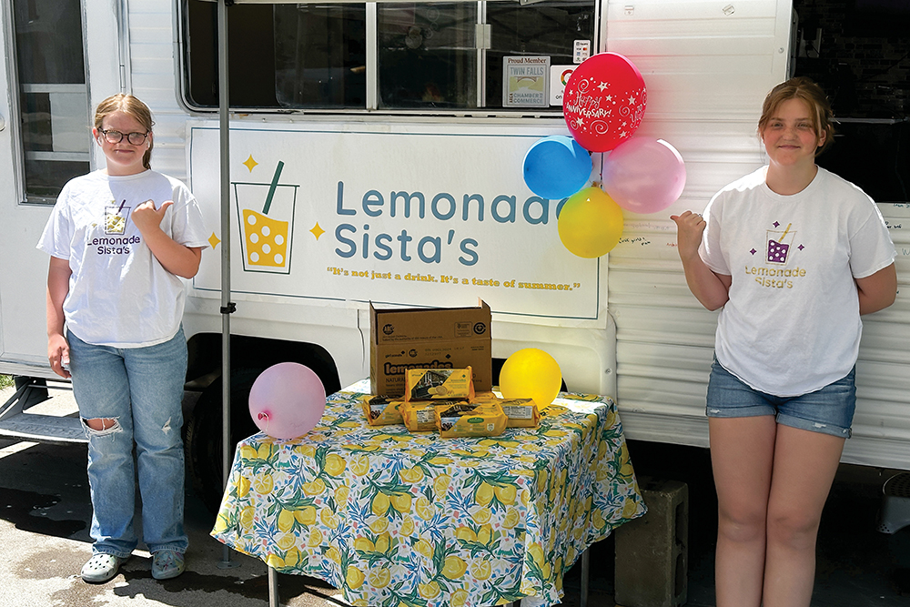 Alacyn and Karleigh Brown pose in front of their Lemonade Sista's food truck in Twin Falls, Idaho.