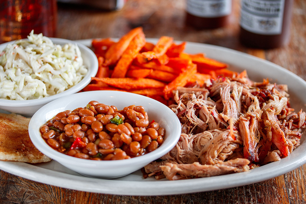 A barbecue platter with beans, slaw and sweet potato fries at Puckett's Restaurant in Franklin, TN.
