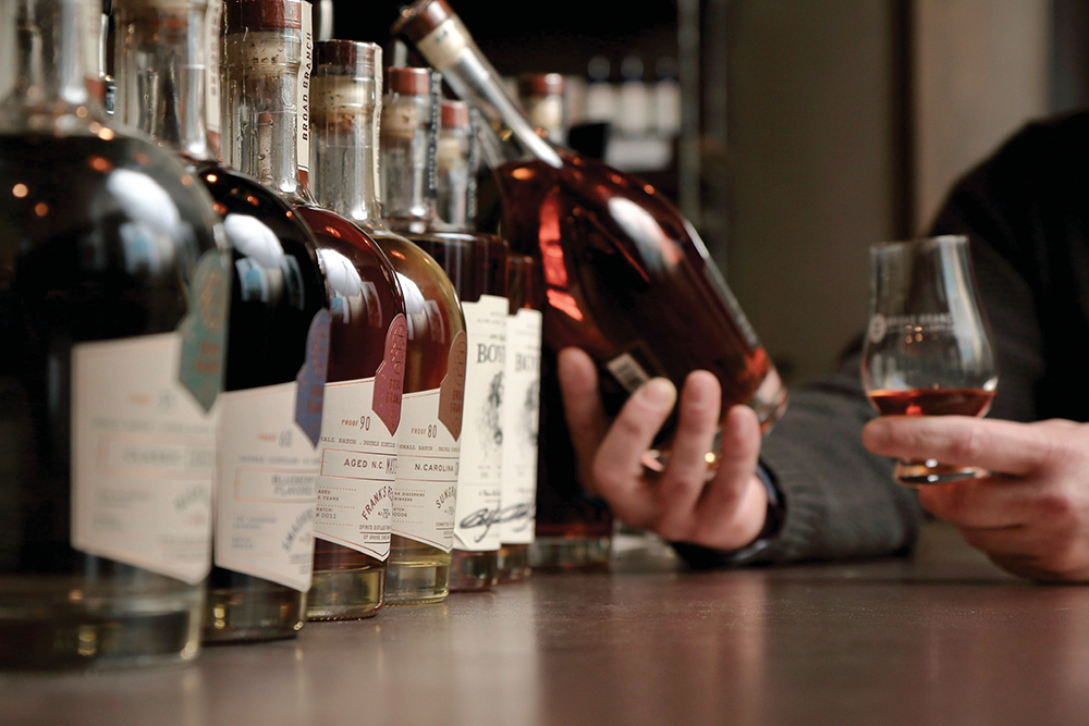 A man tastes whiskey at Broad Branch Distillery in Winston-Salem, NC.