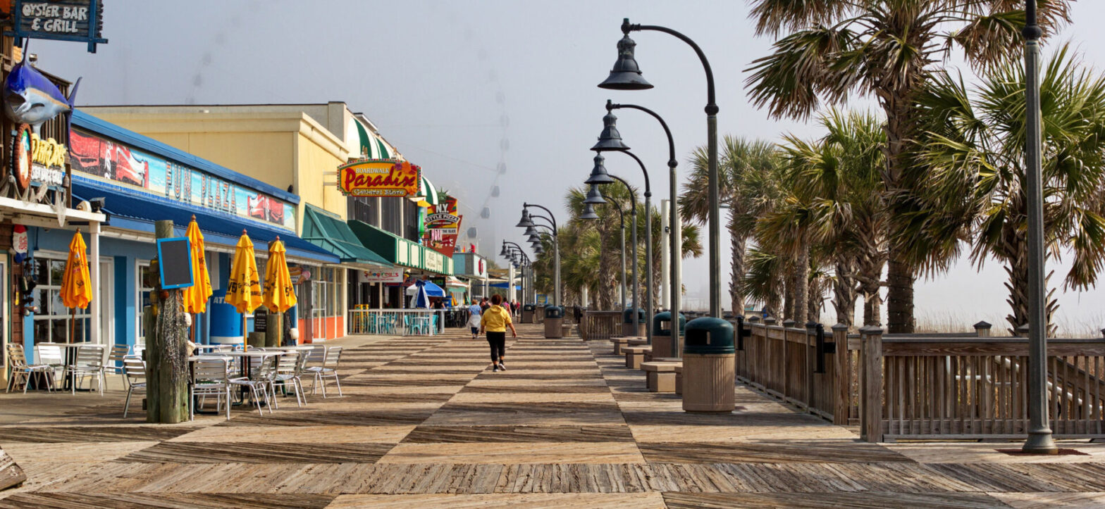 Woman walking along the boardwalk along Myrtle Beach