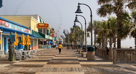 Woman walking along the boardwalk along Myrtle Beach