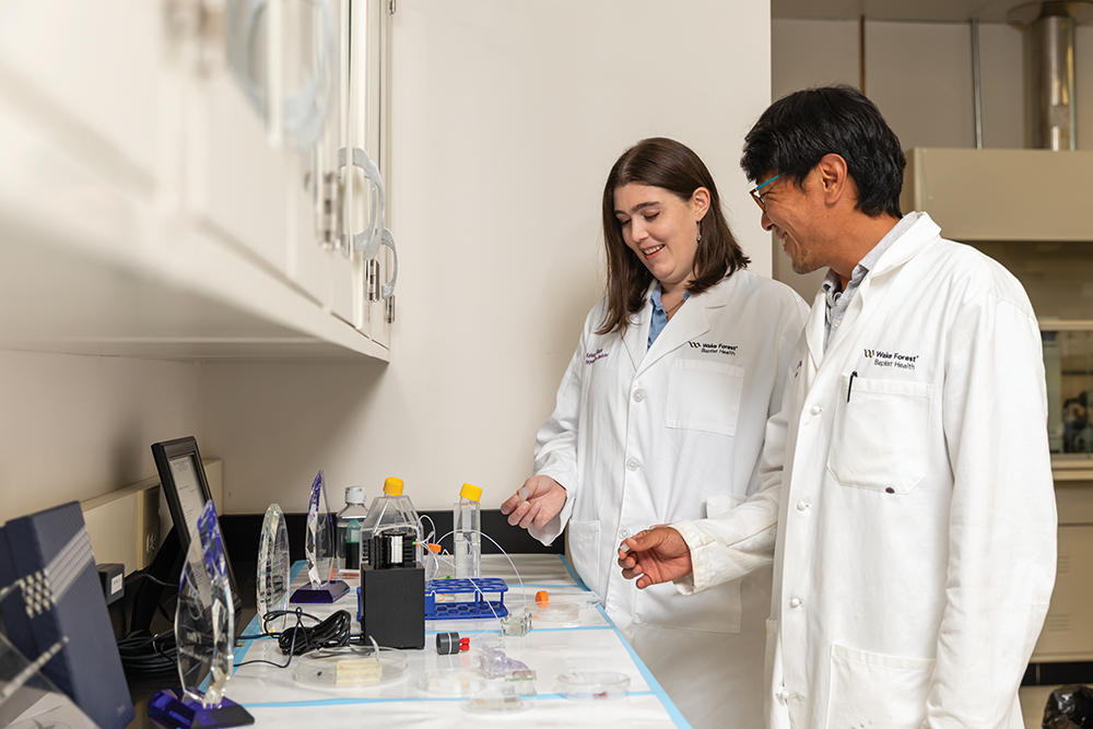Wake Forest Institute for Regenerative Medicine Research Associate Young Wook Moon and grad student Kelsey Willson discuss a bio-printed vascular tissue mold that won 1st and 2nd place in a recent NASA contest.