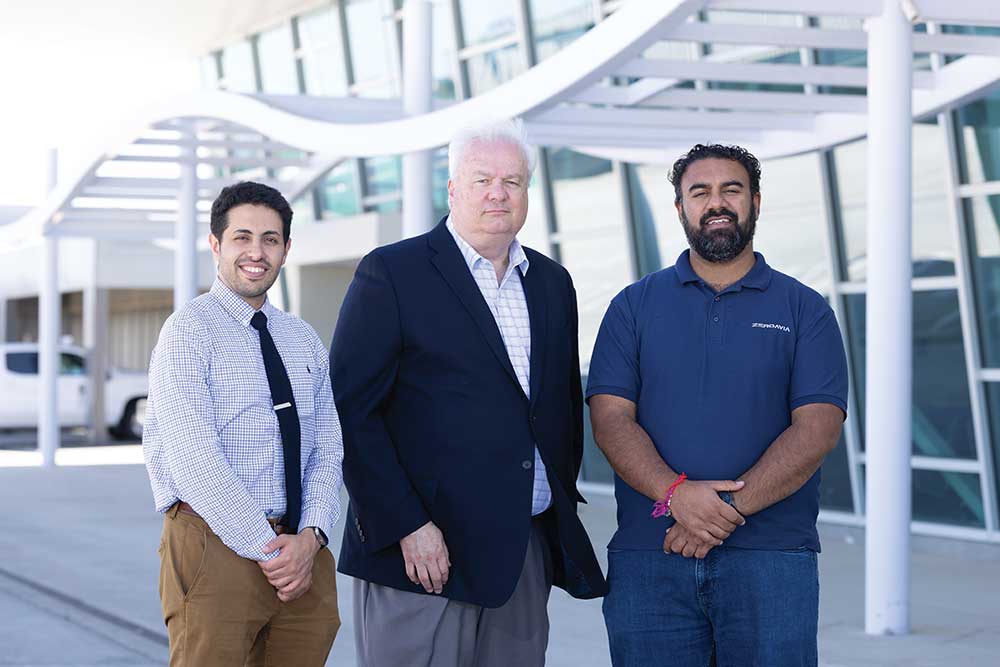 Airport director Richard Sokol (middle) stands between Mahmood Alqefl, left, and Gurjap Singh of ZeroAvia at Stockton Metropolitan Airport in Stockton, California.