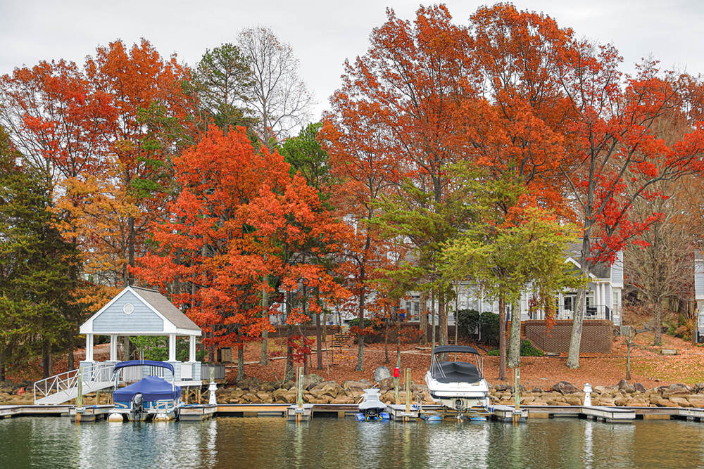 Boats lined up in their slips at the large residential estates on Lake Norman during peak fall season.