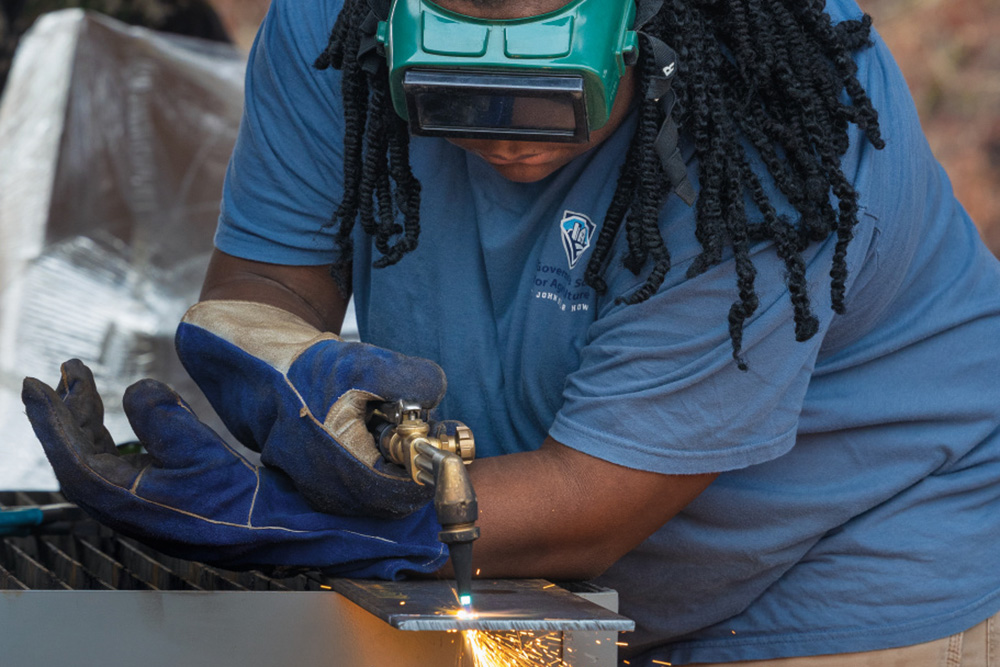 Courtney learning the process of using oxy-acetylene to cut steel at the South Carolina Governor's School for Agriculture at John de la Howe
