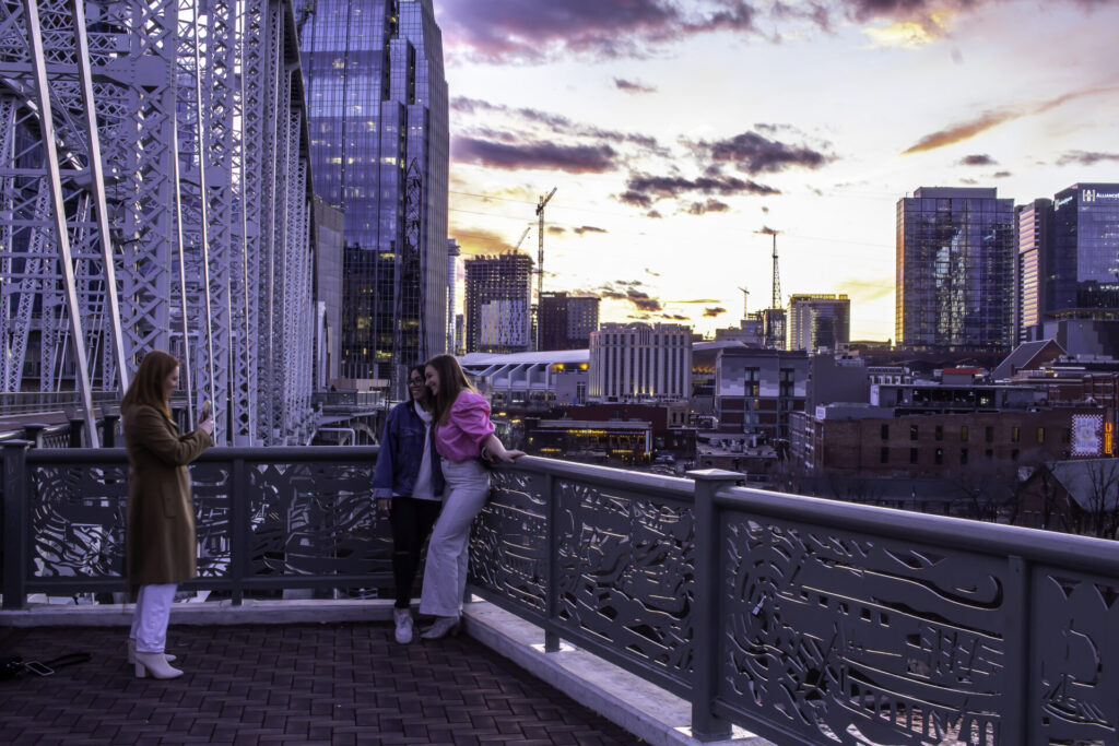 January 17, 2021 - Nashville, Tennessee, U.S.: Tourists posing for a picture in front of downtown Nashville on the John Seigenthaler Pedestrian Bridge.