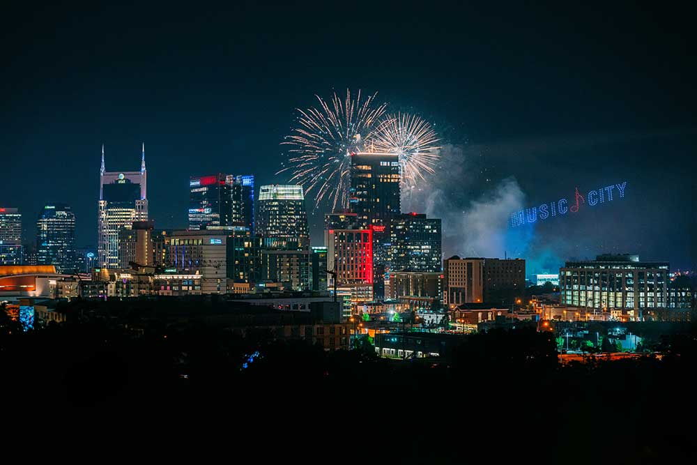 Fireworks over the water in Nashville, TN. Maximize your PTO for 2026 with a trip to Nashville for New Year's.