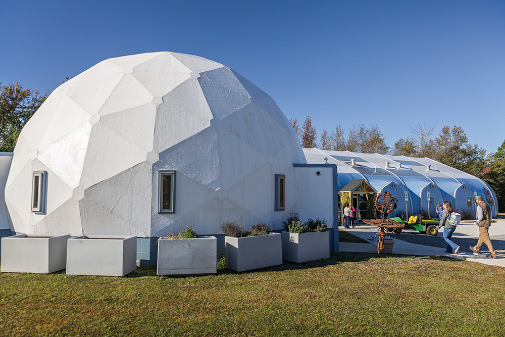 The Nancy & John Bray Environmental Education & Visitor Center at NCMNS Contentnea Creek is anchored by a white geometric dome structure.