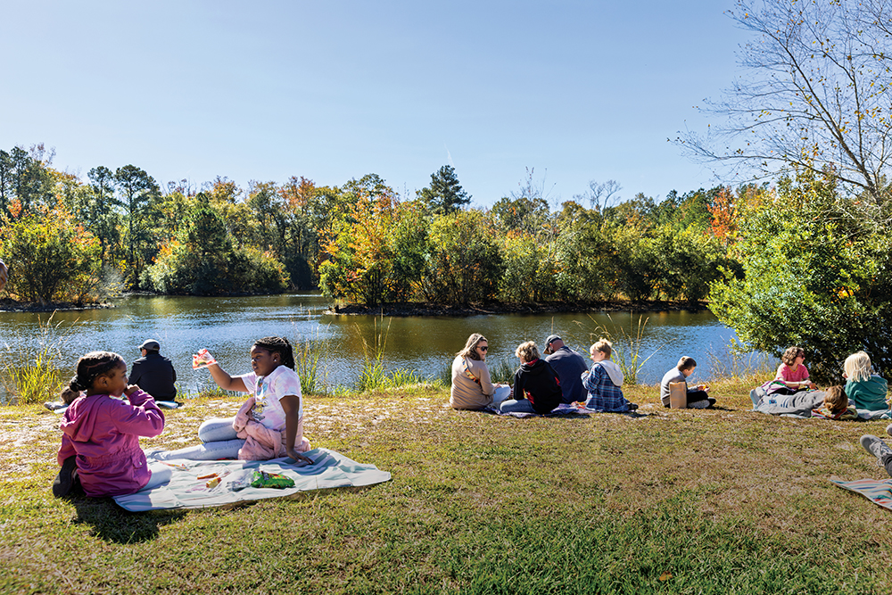 Visitors enjoy a lakeside picnic at the Contentnea Creek branch of North Carolina Museum of Natural Sciences.