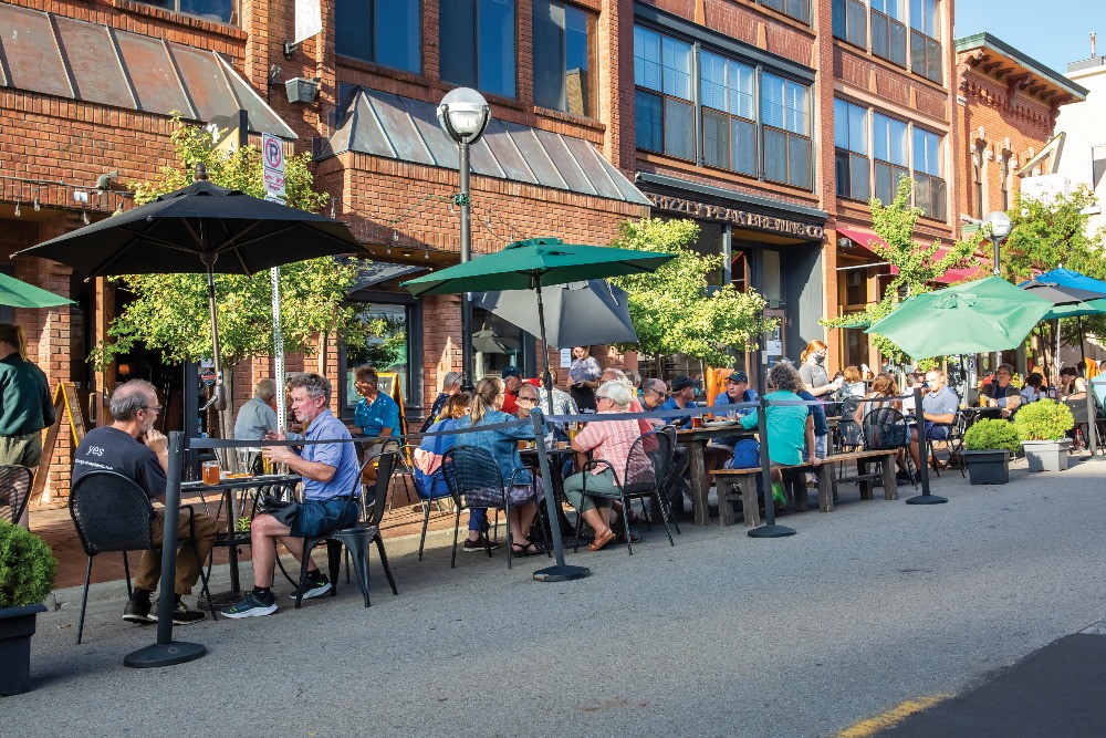 People dine at outdoor tables at Grizzly Peak Brewing Company in Downtown Ann Arbor, MI.