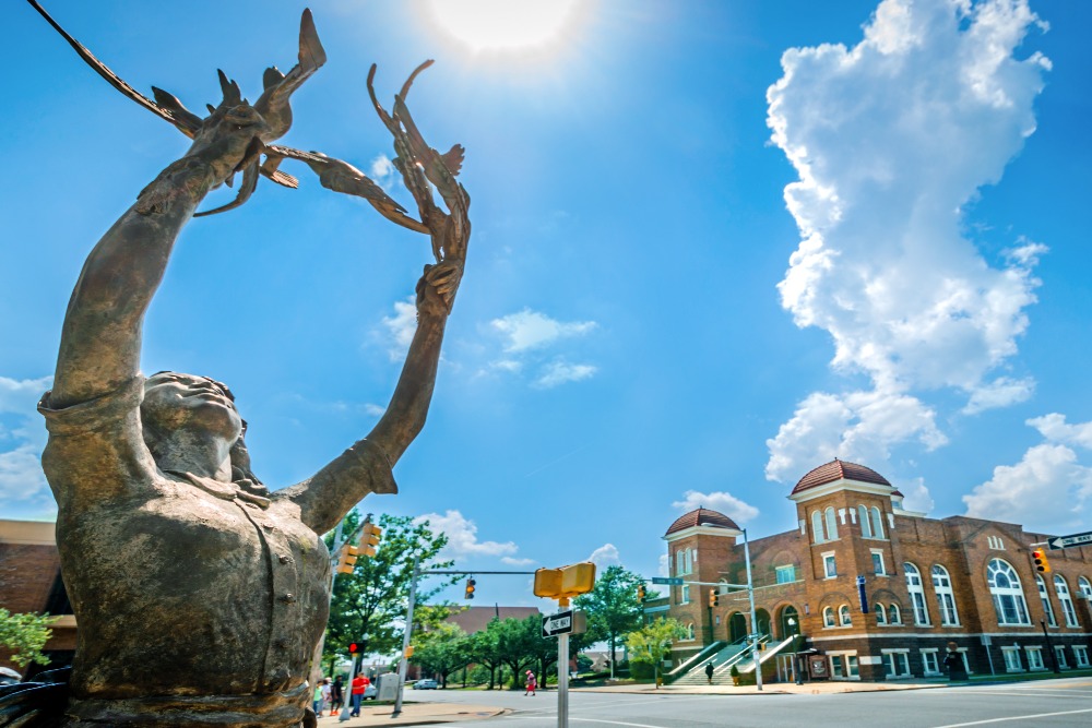 A statue of a girl releasing doves stands at the corner of Kelly Ingram Park, near 16th St. Baptist Church in Birmingham, Alabama. The statue, "Four Spirits," was created by sculptor Elizabeth MacQueen in 2013.
