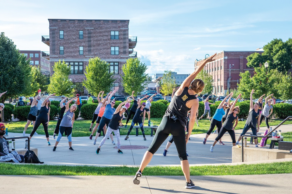 Jill Wistrick leads a Jazzersize group on the lawn of the New Bohemia Market in Cedar Rapids, Iowa.