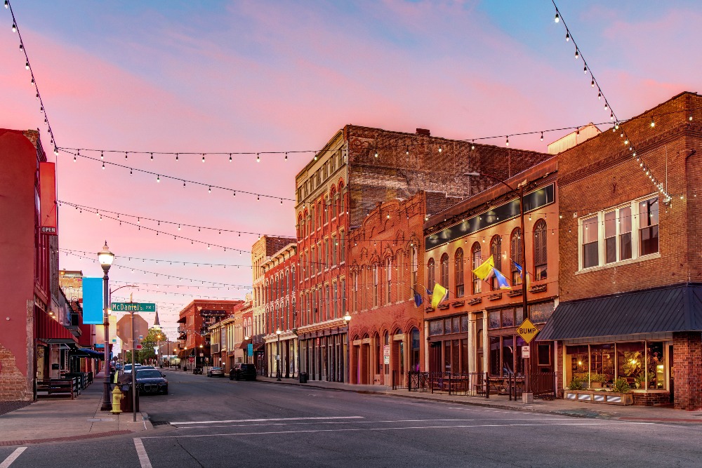 Sunset casts a warm glow on the brick buildings of Downtown Springfield, Missouri. A walkable downtown is one of the perks of living in Springfield, Missouri.