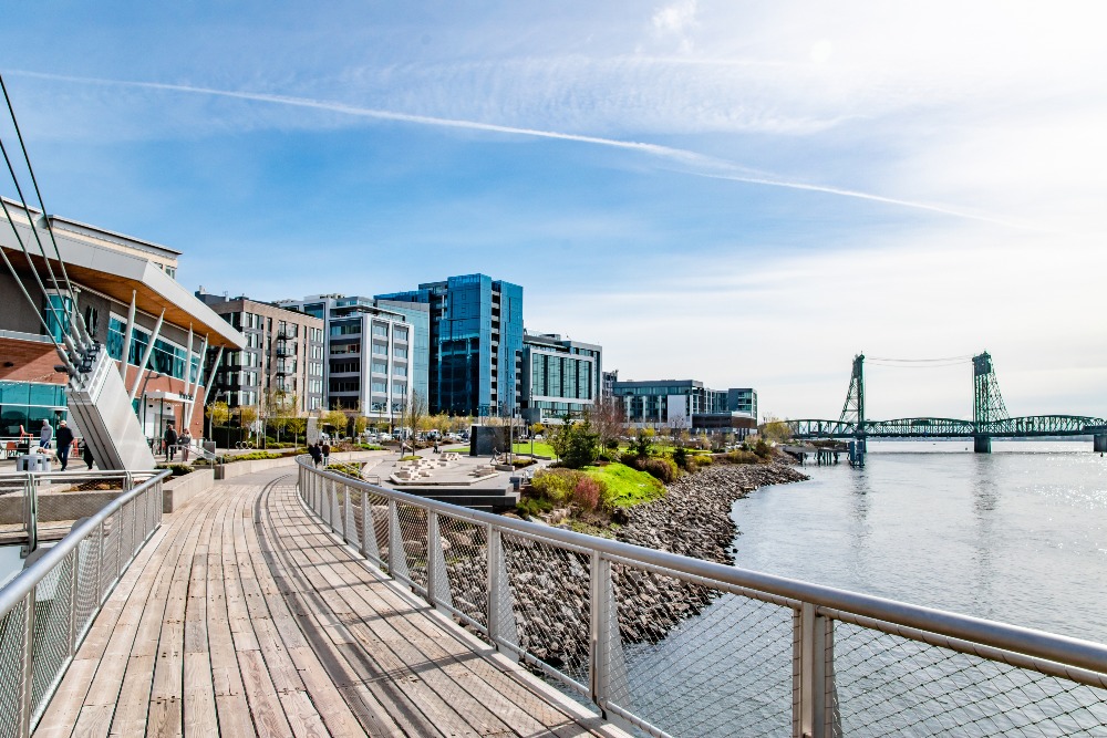 Waterfront Park in Vancouver, WA, is framed by skyline views of skyscrapers and bridges.