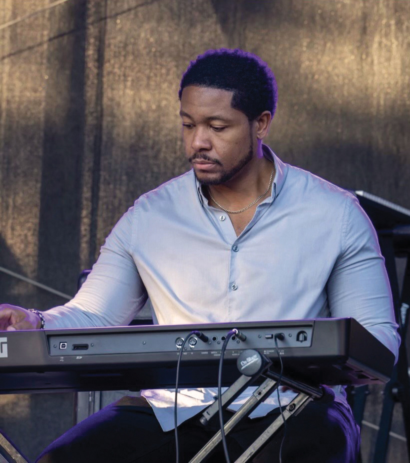 North Carolina native Quincy Jones play keyboard at a performance.