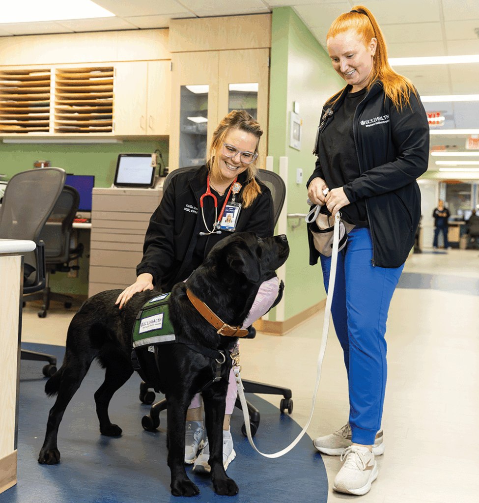 Nurse practitioner Katie Uzelac, shown on left petting a dog