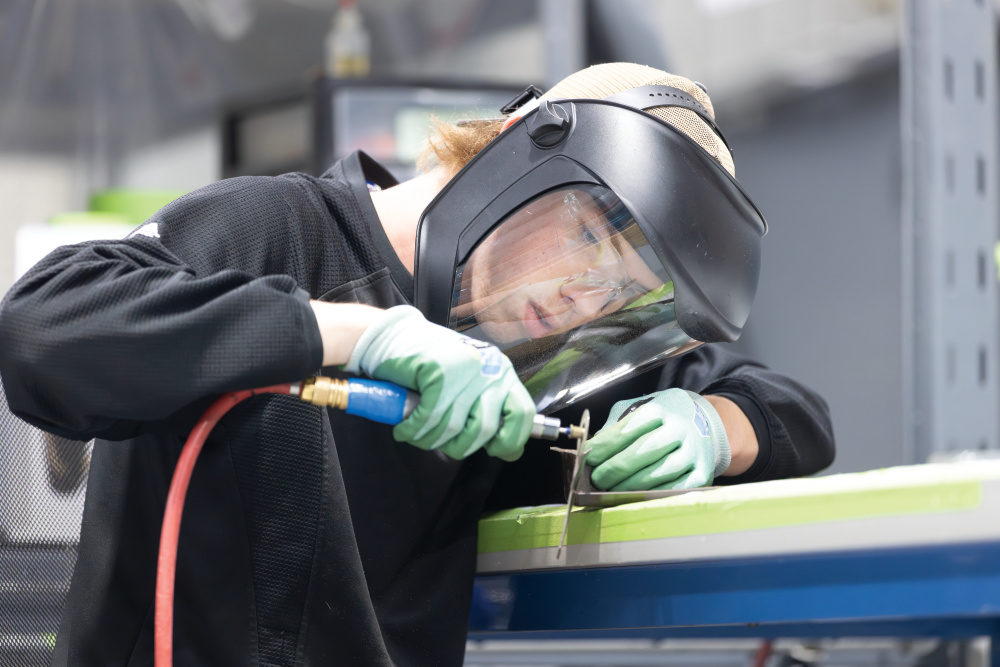 A Work Based Learning student works on manufacturing helicopter parts at the Aeronautical Accessories manufacturing facility at Bell (Textron) Piney Flats in Piney Flats, Tennessee