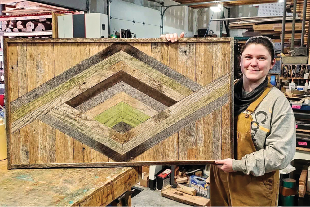 Johnson City woodworker Lacy Snapp shows off one of her reclaimed wood creations.