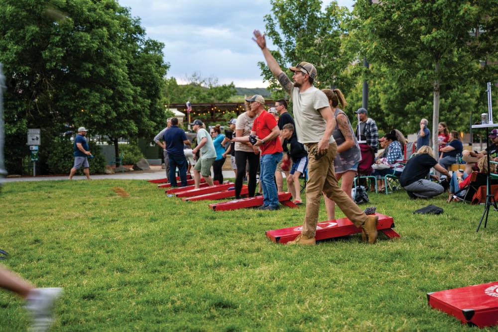 Locals enjoy a cornhole tournament at Festival Park in Castle Rock