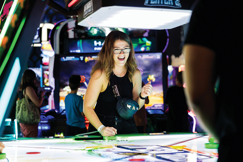 A couple plays games at Andretti Indoor Karting & Games in Overland Parks, KS.