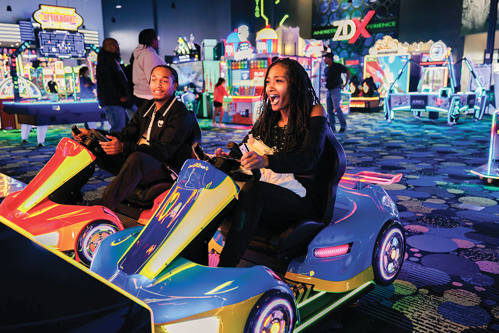 A couple plays a game that simulates driving bumper cars at Andretti Indoor Karting & Games in Overland Park, KS.