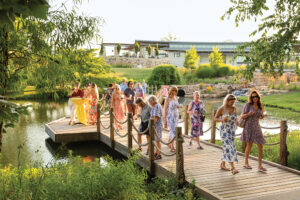 Visitors sip cocktails while enjoying the gardens at Stems: A Garden Soiree at Overland Park Arboretum & Botanical Gardens in 2025.