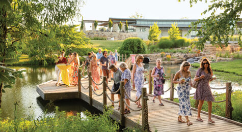 Visitors sip cocktails while enjoying the gardens at Stems: A Garden Soiree at Overland Park Arboretum & Botanical Gardens in 2025.