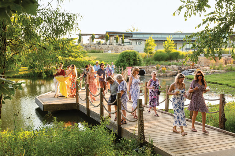 Visitors sip cocktails while enjoying the gardens at Stems: A Garden Soiree at Overland Park Arboretum & Botanical Gardens in 2025.