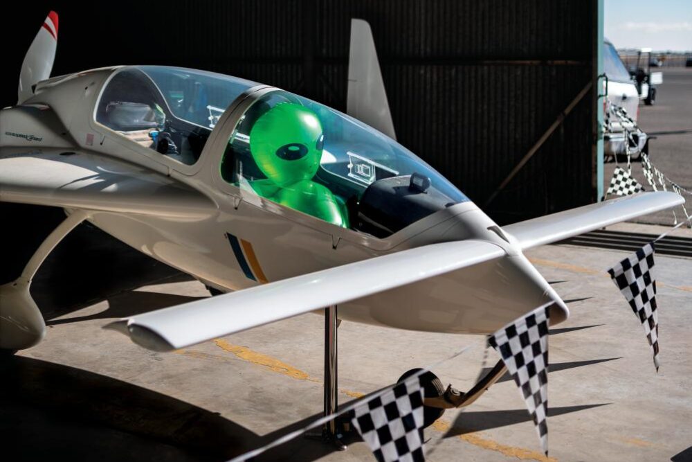 person dressed as an alien in a plane