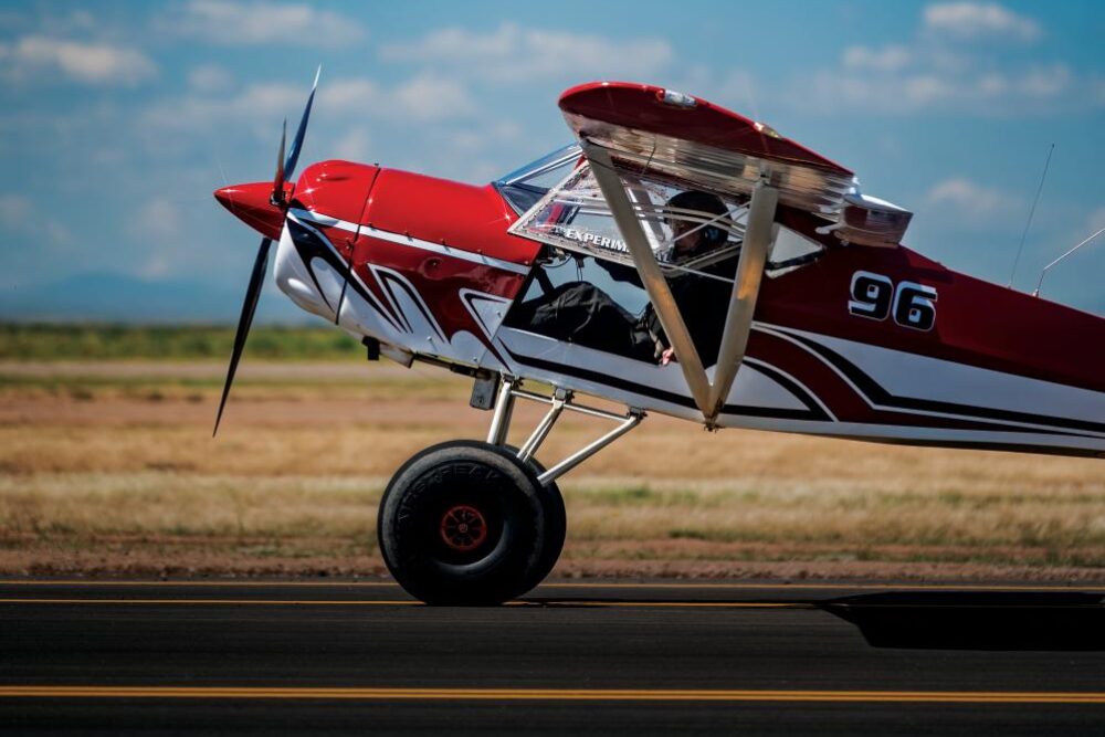 red plane taking off from the runway