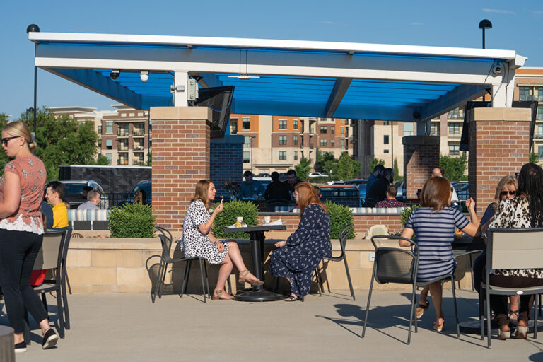 Employees eat lunch on the patio at WellSky with views of downtown Overland Park, KS.