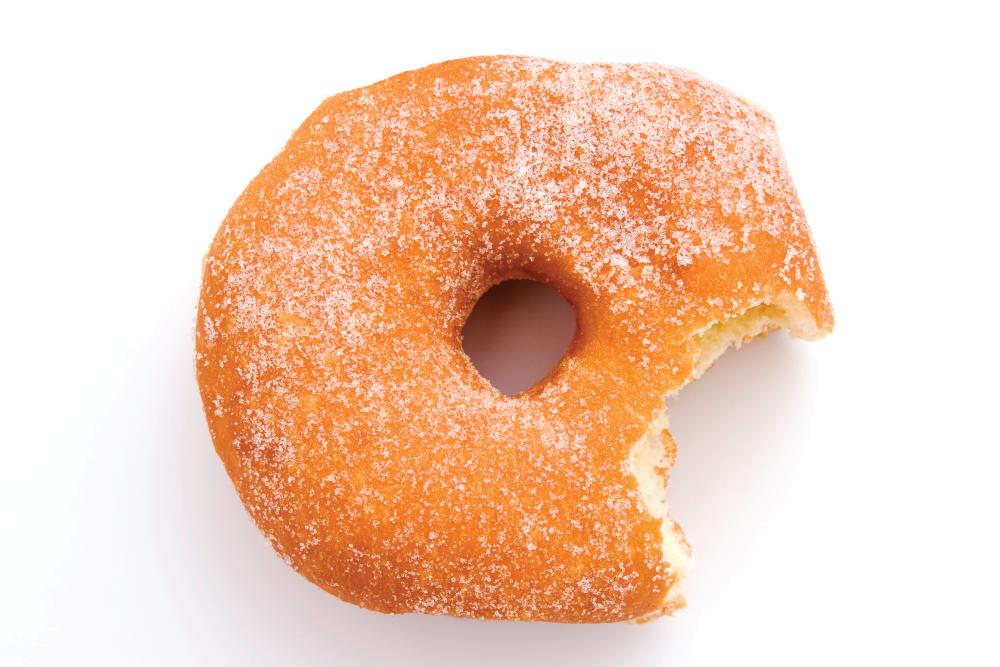high angle view of sugar donut with bite missing, isolated on white