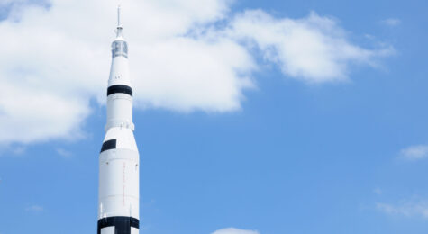 Horizontal composition of Saturn V (5) rocket with copy space and clouds.