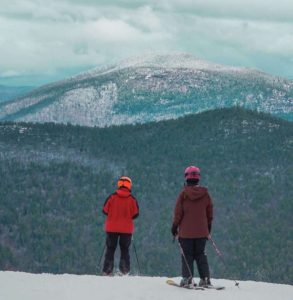 Skiers atop the mountain at Attitash Mountain Resort.
